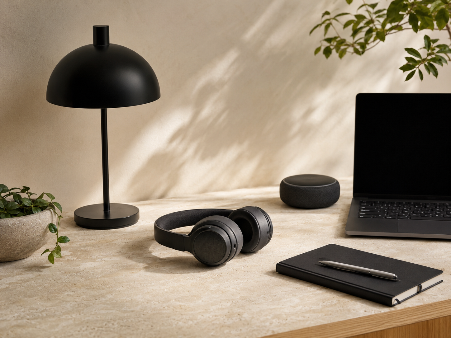 A considered selection of home-office tools on a warm stone desk